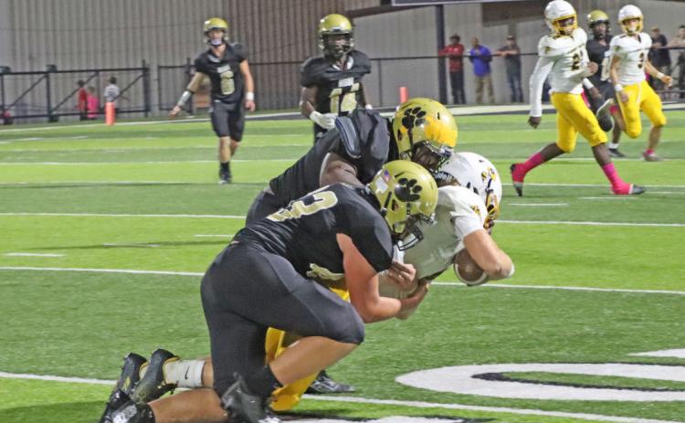 TWO-WAY CONTRIBUTOR - Rison senior offensive/defensive lineman Trevion Johnson (tackler on top) brings down Harmony Grove quarterback Caleb Johnson with an assist from the Wildcats’ sophomore lineman Thomas Wilson. Rison Coach Clay Totty said Johnson played his best game of the season, grading out highest among the offensive linemen who all graded out at championship level. (Photo by Chris Phillips)
