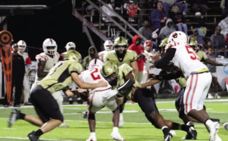 TAKING DOWN A PIRATE - Rison’s Jaquis Rauls (center, no. 6) makes contact with the Drew Central quarterback before teammate Eli Turner (left, no. 33) comes in to assist on the 14-yard sack on fourth-and-seven in the second quarter. The Wildcats drove the 56 yards in 16 plays to take a 27-13 lead into halftime. Rauls had a huge game defensively, recording nine tackles, five solo tackles and one turnover.