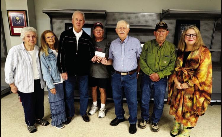 HISTORICAL SOCIETY DONATES TO VETERANS ASSOCIATION DISPLAY - Members of the Cleveland County Historical Society pr esented a $500 check to the Cleveland County Veteran's Association to help fund glass cases for the display being installed in the Hall-Morgan Veteran's Building. Pictured are Annette Rawls, Karen Bell Fox, Wayne Cash, Randy Morgan, Rickey Fore, Allen Wilson and Suzi Parker.