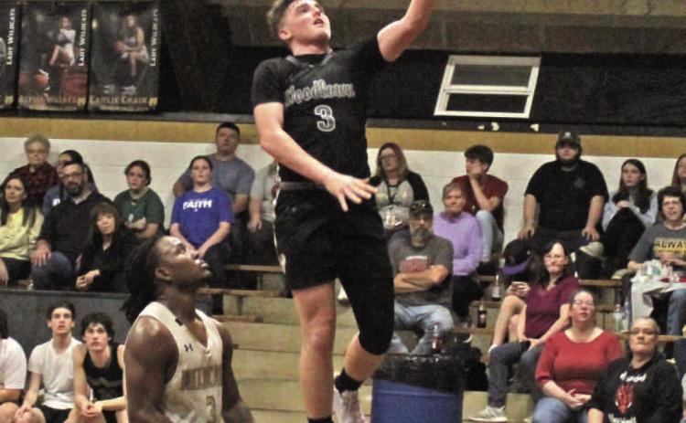 WEATHERFORD GETS RED HOT - Woodlawn's Garrett Weatherford drive a layup against Rison's Za'Kyler Waker during second half action of the regular season finale last Friday night inside the Rison Gym. Weatherford buried four of his five 3-pointers in the third quarter as the Bears pulled away for the 76-48 victory.
