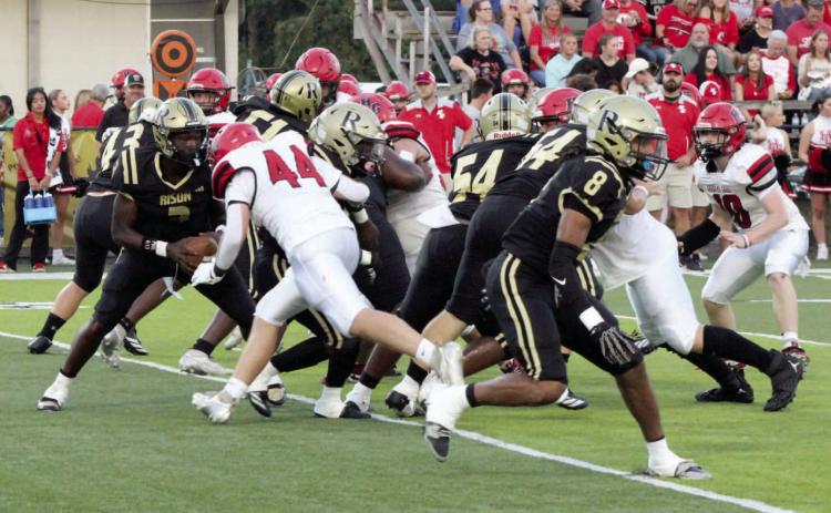 NOWHERE TO GO - Rison quarterback Kyson Walker (3) tries to fol low the block of running back Jeramiah Marshall while a Harmony Grove defender closes in during first half action of last Thursday's game at George Walker Field of Champions. The Cardinals held the Wildcats to 65 yards of offense and three first downs. Also pictured for Rison are offensive linemen Galvin Wilson, Jr. (54), Tanner Collins (64) and running back Kyson Fletcher (8).