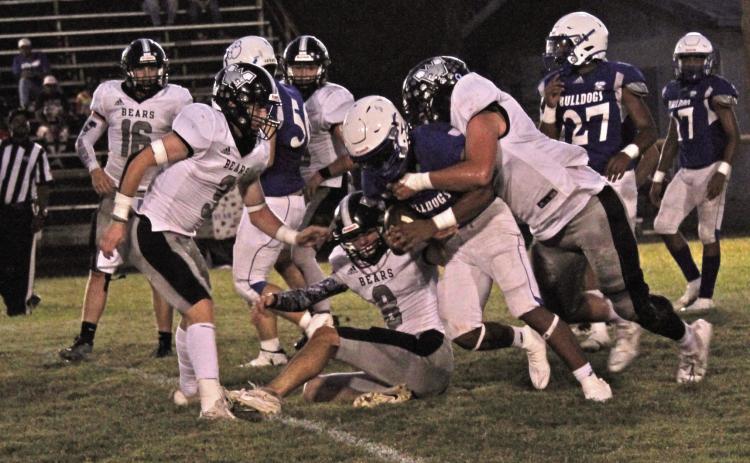 BRINGING DOWN A BULLDOG - Woodlawn’s Brayden Kitchens (right) brings down Strong’s Germyren McHenry after the Bears’ Aidan Johnson (no. 8, center) corralled McHenry by his shirt. The Bulldogs used their speed advantage throughout the game to test the Bears’ defense, both on the ground and through the air. Also pictured for Woodlawn are Ethan Oliver (no. 16) and Garrett Weatherford (no. 3).