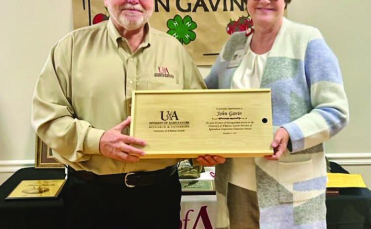 JOHN GAVIN RETIRING AFTER 42 YEARS OF SERVICE - Arkansas Cooperative Extension Service Ouachita District Director Carla Due (left) presents Bradley County Ag Extension Agent John Gavin (right) a barbeque grilling set during Gavin's retirement party on Dec. 17 in Warren. (Photo compliments of University of Arkansas Division of Agriculture)