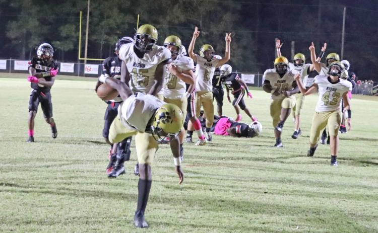 WAINWRIGHT PUTS RISON BACK ON TOP - With his teammates already celebrating in the background, Rison’s Treyvion Wainwright (foreground) lunges across the goal line to put the Wildcats back on top, 24-16, with 4:41 left in game. Wainwright had an outstanding game overall, recording six tackles and five pass break-ups on defense and then intercepting and returning a lateral on Fordyce’s last-ditch kickoff return for a touchdown. (Photo by Chris Phillips)