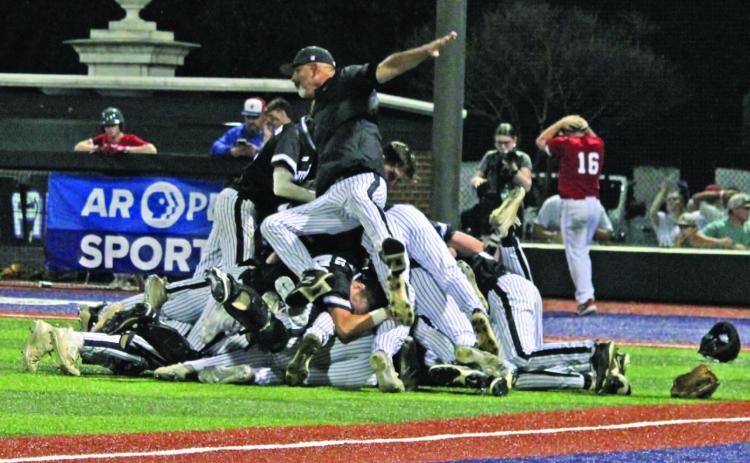 Woodlawn Coach Tommy Richardson backs onto the dogpile following the Bears' 3-2 nail-biting victory over the Palestine-Wheatley Patriots last Friday night at the University of Central Arkansas in Conway. Richardson has guided Woodlawn to 12 appearances in the state championship game, winning nine of those.