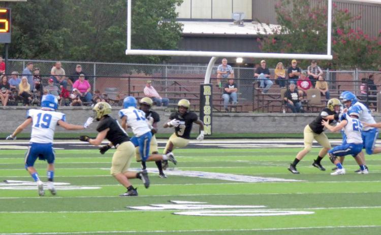 BIG HOLE FOR WALKER - Rison junior kick returner ZaKyler Waker (center, no. 3) finds a huge hole in the middle of the field as he turns upfield on his way to a 96-yard touchdown return on the opening kickoff of the Wildcats’ nonconference game with the Bismarck Lions Friday night at George Walker Field of Champions. Setting up the blocks for the big kickoff return are Rison teammates Ryan Hyatt (left), DJ Kings (second from left) and James Mitchell (right). (Photo by Michelle Rawls)