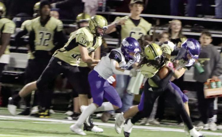 NO EASY YARDS - Rison's Jeramiah Marshall tries to shake off a couple of Jessieville defenders near midfield during second half action of last Friday's first round playoff game at George Walker Field of Champions. Rison finished the game with 147 yards rushing on 38 attempts to average 3.8 yards per run. Trailing on the play for the Wildcats is Eli Turner (no. 33) who caught a touchdown pass in the closing minutes for Rison's final score of the game. (Photo by Chris Phillips)