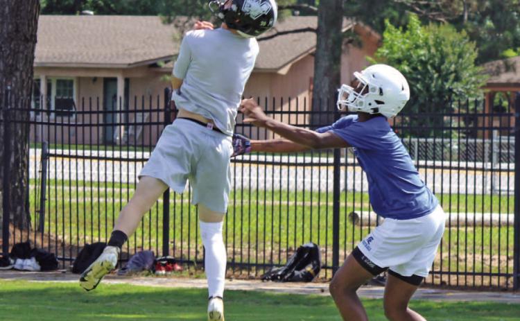 PICK MACHINE - Woodlawn junior defensive back Ethan Adair goes up to pull in one of six interceptions he made during Tuesday's 5-on-5 camp at the Carl Jones Sports Complex. Woodlawn had eight picks for the day with Aidan Johnson and Ethan Oliver making the other two.